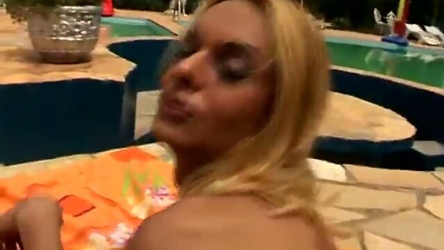 Shemale has fun poolside