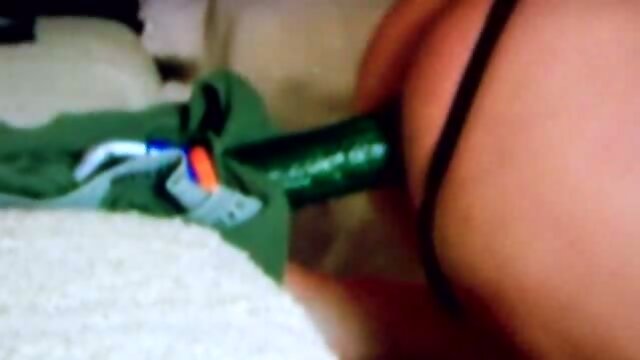 Tranny takes cucumber in ass