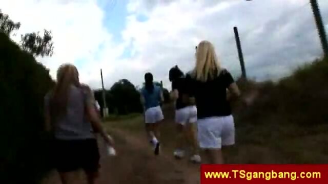 Sporty shemales stretch outdoors