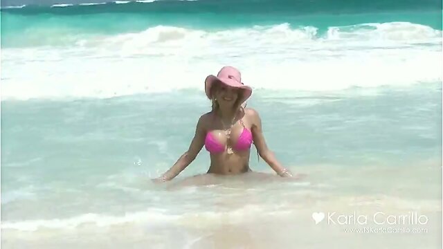 Karla Carrillo in the pink hat on the beach
