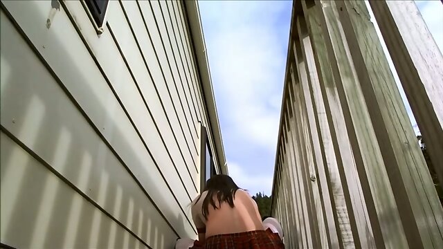 Crossdressing as school gurl on outdoor deck