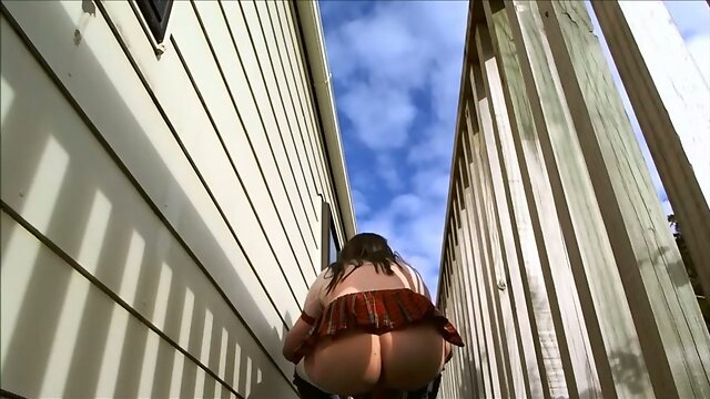 Crossdressing as school gurl on outdoor deck