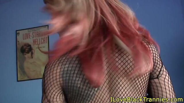 Tattooed ebony tranny plays with her cock