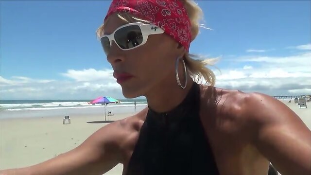 sexy leather biker in thigh boots on the beach