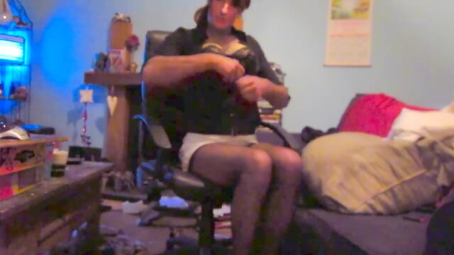 Wearing a white mini skirt suit, stockings & high heels