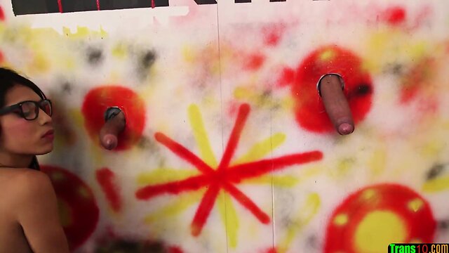 Stockinged specs tranny goes down on dicks