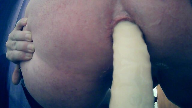 Sitting on a huge sextoy, stretching open my hole