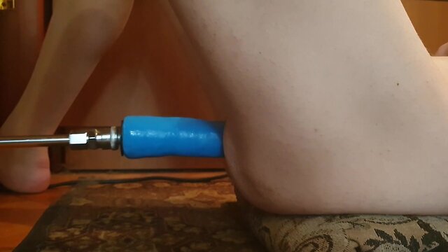 Naked person engaging in sexual activity with a fucking machine