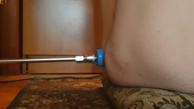 Naked person engaging in sexual activity with a fucking machine