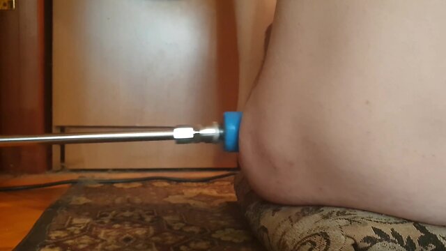 Naked person engaging in sexual activity with a fucking machine