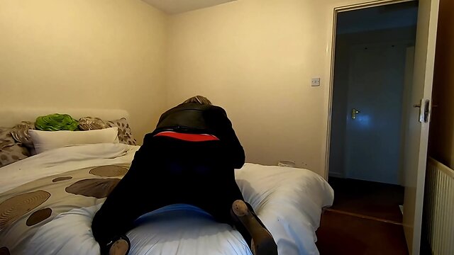 Kelly taking pleasure in bedroom play in ebony pvc leggings and cumming