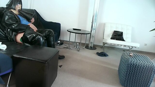 Latex nun sitting on giant assplug