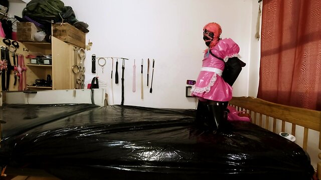 Maid hogtied and gagged in armbinder and steel chastity belt