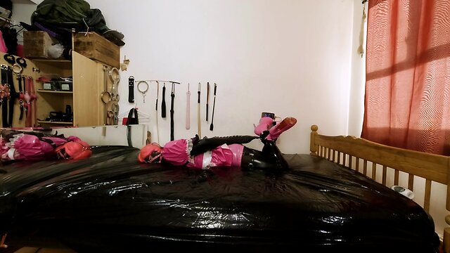 Maid hogtied and gagged in armbinder and steel chastity belt