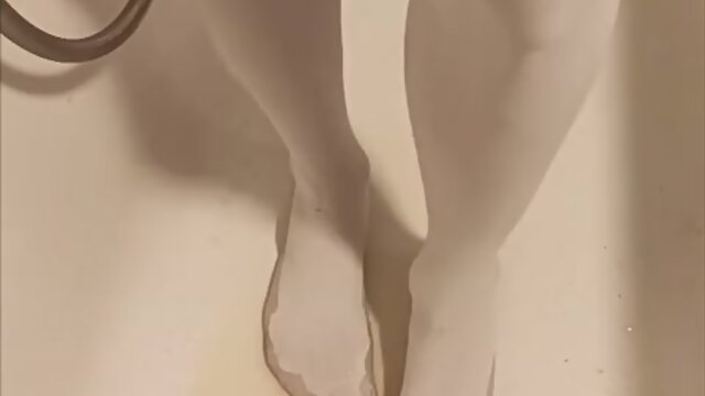 Trans person pisses pantyhose, licks wet feet and fucks self with fat dildo