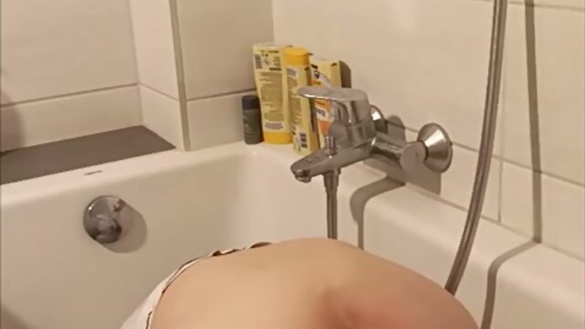 Trans person pisses pantyhose, licks wet feet and fucks self with fat dildo