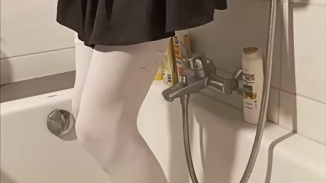 Trans person pisses pantyhose, licks wet feet and fucks self with fat dildo