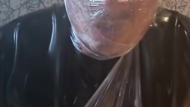 Breath play in latex catsuit with cling film