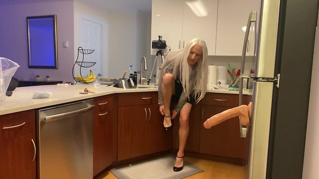 Crossdresser fucked with dildo in kitchen