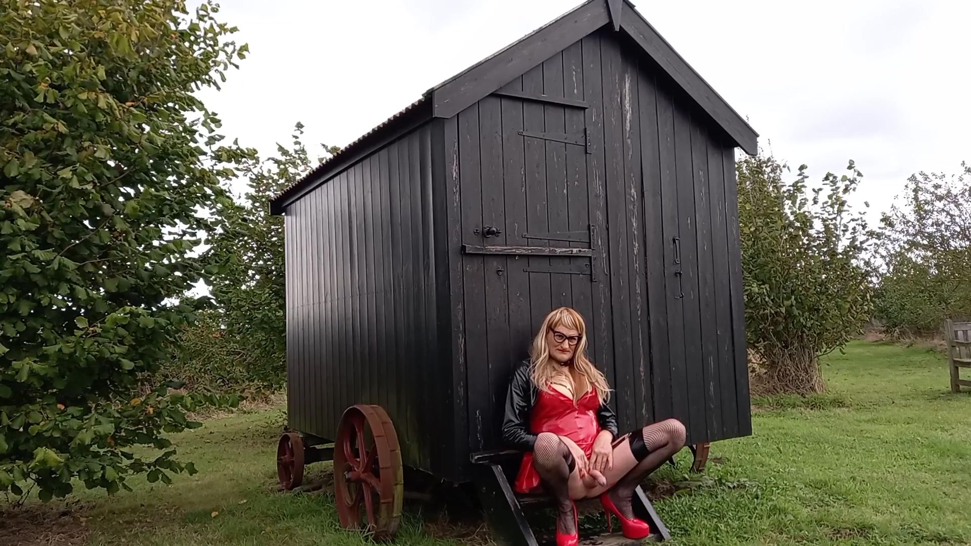 Pvc-clad trans person cumming outdoors in the rain