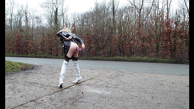 Transgender person ejaculating milk from their rear end outdoors