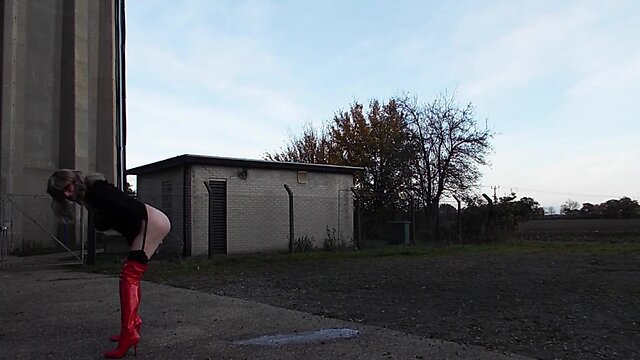 Transgender person ejaculating milk from their rear end outdoors