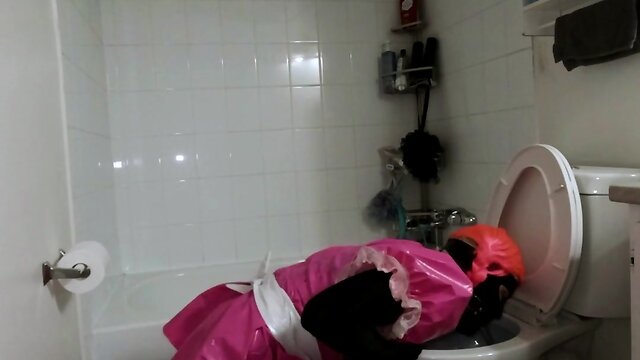 Steel chastity belt and dildo cleaning bathroom by a sissy maid