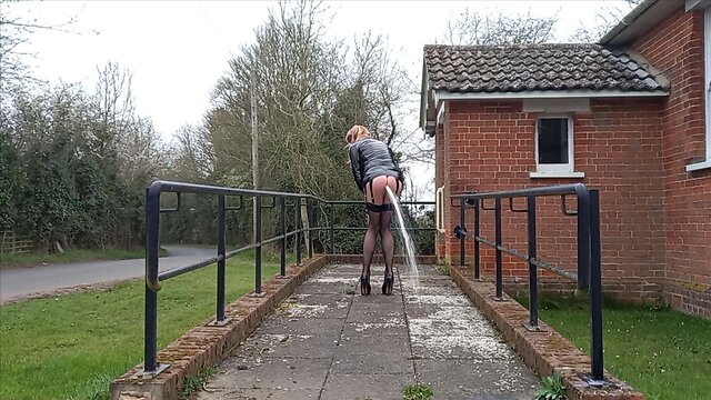 Squirting crossdresser in pvc masturbates outdoors