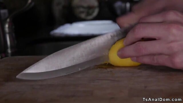 Transgender with massive penis dominates man in kitchen.