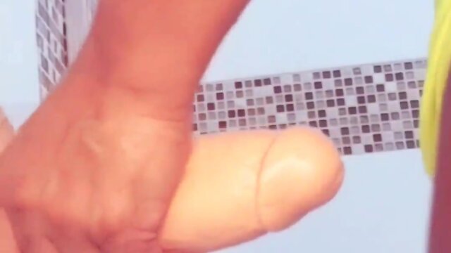 Attempting to insert a dildo in the butt