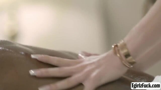 Experience the sensational deepthroating skills of a busty transsexual with a big black cock