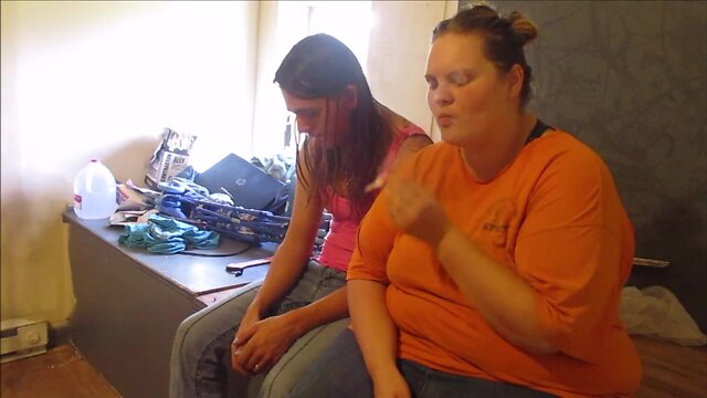 Sexy women share a cigarette and pleasure each other