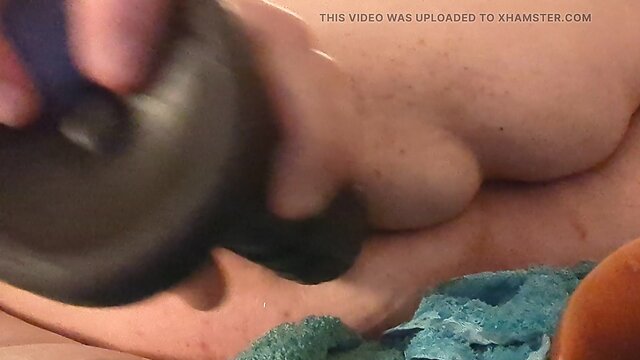 Sissy fills her rear with massive dildo