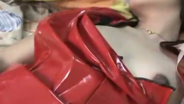 Asian ladyboy in latex dress jerks.