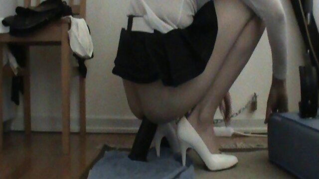 Chained tgirl sits on a dildo