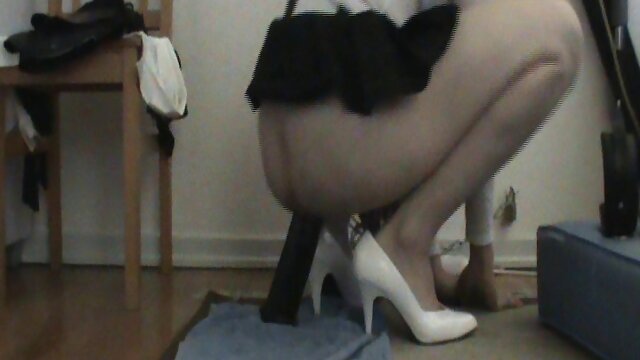 Chained tgirl sits on a dildo